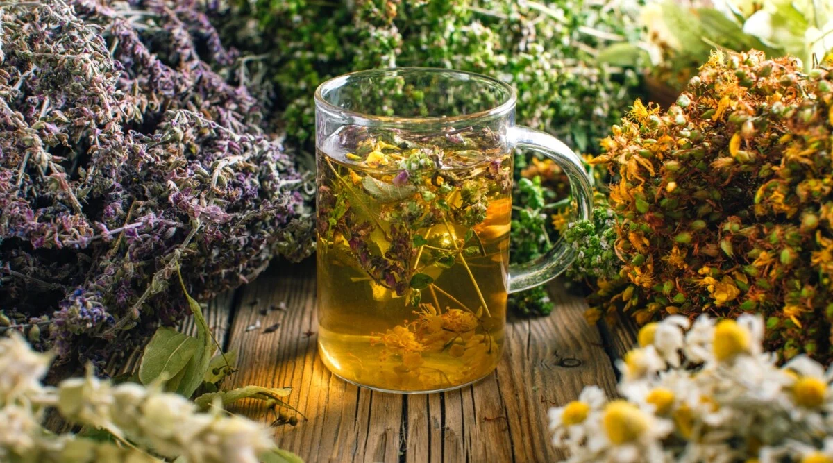 Herbal tea brewing setup with kettle and loose leaves
